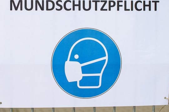 Ein Schild weist auf das verpflichtende Tragen einer Maske hin