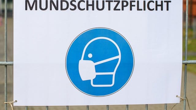 Ein Schild weist auf das verpflichtende Tragen einer Maske hin