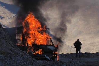 Ein Mann neben einem brennenden Auto in Bergkarabach: Der Krieg um die umkämpfte Region dauert an.