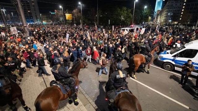 Teilnehmer der Demonstration stehen am Leipziger Hauptbahnhof vor der Reiterstaffel der Polizei. Teilnehmer der Demonstration stehen am Leipziger Hauptbahnhof vor der Reiterstaffel der Polizei.