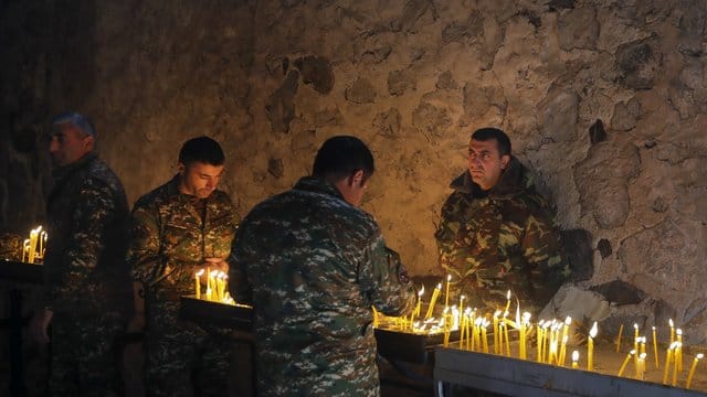 Armenische Soldaten entzünden Kerzen in einem orthodoxen Kloster in Berg-Karabach. Armenische Soldaten entzünden Kerzen in einem orthodoxen Kloster in Berg-Karabach.