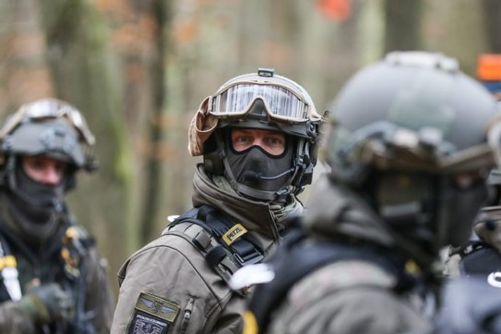 Polizisten mit Schutzausrüstung nehmen an einem Großeinsatz im Dannenröder Forst teil.