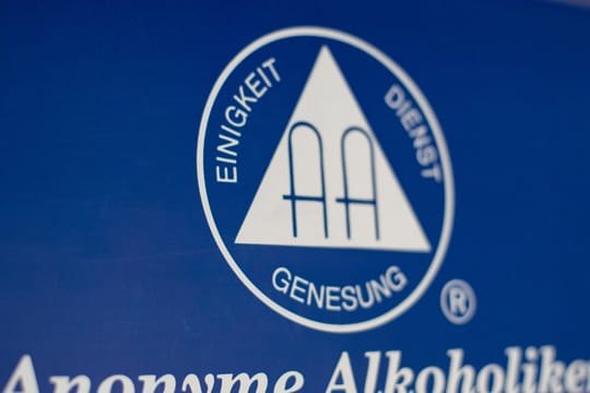 Das Logo der Anonymen Alkoholiker hängt an einer Wand