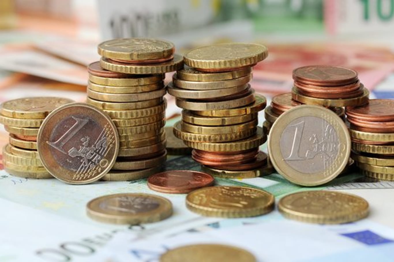 Euro-Münzen auf Euro-Banknoten: Viel Geld fließt in Hilfen für Unternehmer während der Corona-Krise.