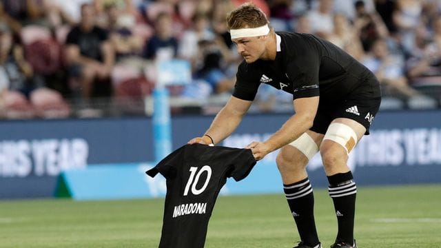 Sam Cane, Kapitän der "All Blacks", legt vor dem Spiel der neuseeländischen Rugby-Nationalmannschaft gegen Argentinien das All-Black-Trikot mit Maradonas Nummer 10 auf das Spielfeld.