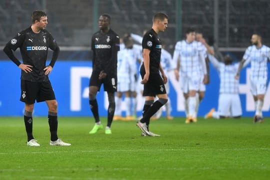 Mönchengladbachs Christoph Kramer (l-r), Denis Zakaria und Matthias Ginter stehen nach dem Gegentor zum 1:3 enttäuscht auf dem Rasen.