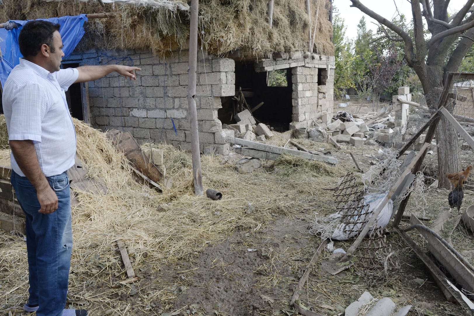 Ein Mann steht vor einer Ruine: Die Kämpfe um die Konfliktregion Bergkarabach haben mehr als 4.600 Menschen das Leben gekostet.