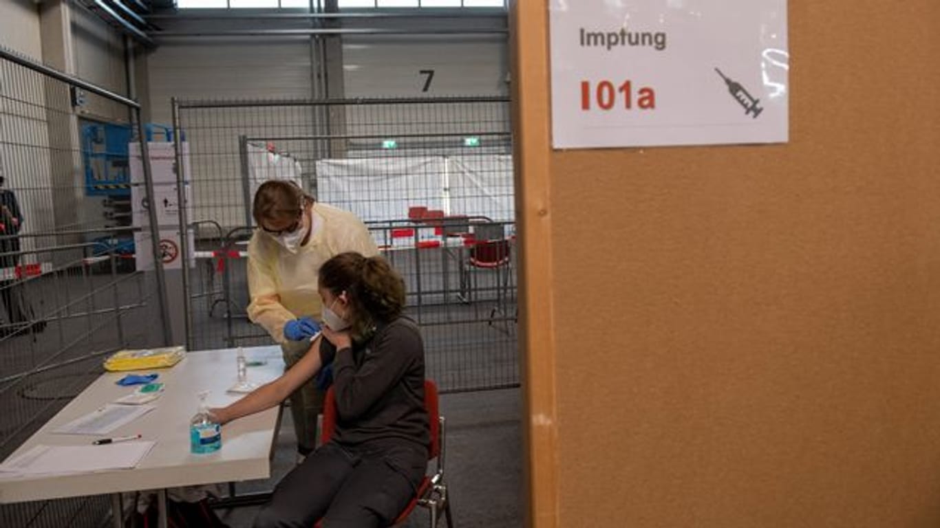 Mitarbeiterinnen des Deutschen Roten Kreuzes simulieren im Ulmer Messezentrum eine Impfung.