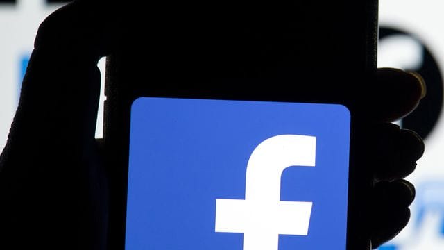 Das Facebook-Logo auf dem Display eines Mobiltelefons. Das Facebook-Logo auf dem Display eines Mobiltelefons.