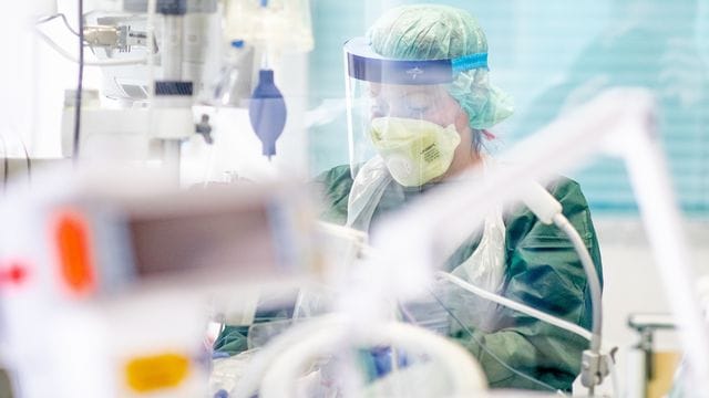 Eine Krankenpflegerin in einem Krankenzimmer auf der Intensivstation des Uniklinikums in Essen.