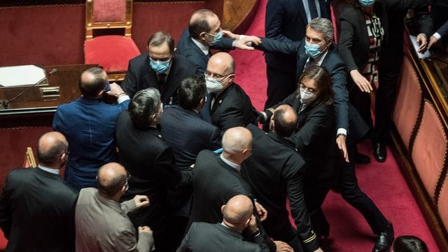Platzanweiser (M) verhindern, dass Senatsmitglieder der Lega Nord (l) mit Mitgliedern der Demokratischen Partei im Senat aneinandergeraten. Platzanweiser (M) verhindern, dass Senatsmitglieder der Lega Nord (l) mit Mitgliedern der Demokratischen Partei im Senat aneinandergeraten.