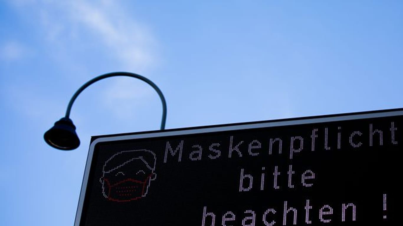 Ein Schild weist auf die Maskenpflicht hin.