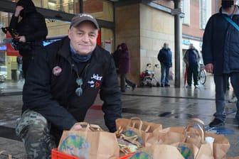 Peter Könnecke steht mit gepackten Tüten vor dem Kieler Hauptbahnhof: Etwa 60 bis 100 Obdachlose kommen zur Lebensmittelausgabe.