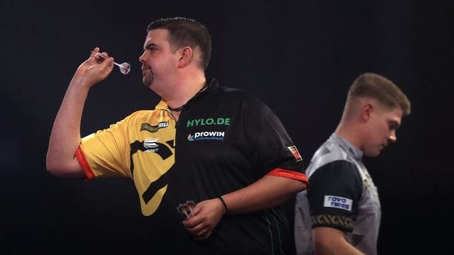 Gabriel Clemens (l) hat das erste deutsche Duell in der Geschichte der Darts-WM gegen Nico Kurz (r) mit 3:1 für sich entscheiden können. Gabriel Clemens (l) hat das erste deutsche Duell in der Geschichte der Darts-WM gegen Nico Kurz (r) mit 3:1 für sich entscheiden können.