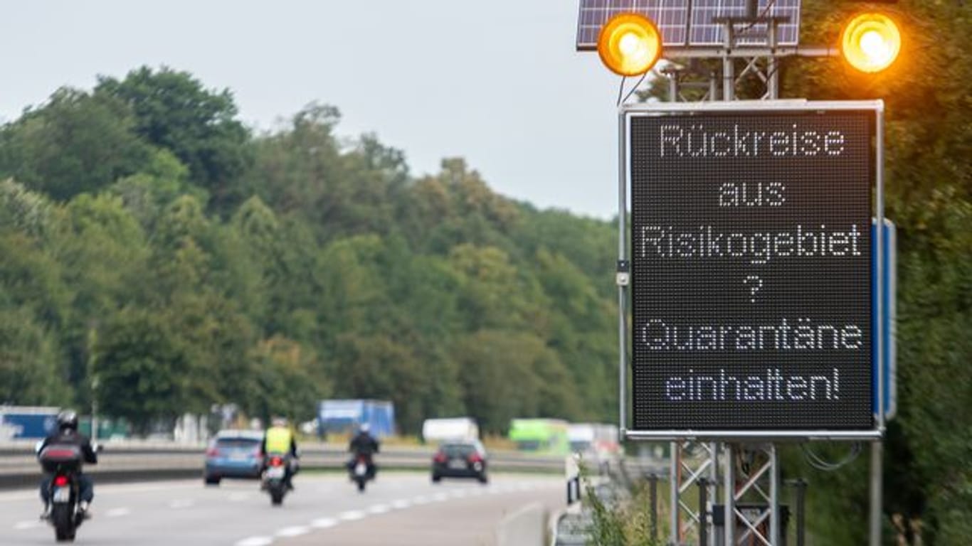 Auf der Autobahn A7 werden Reisende aus Risikogebieten mit einer Leuchttafel "Rückreise aus Risikogebiet? Quarantäne einhalten!" auf die notwendigen Quarantänemaßnahmen hingewiesen.