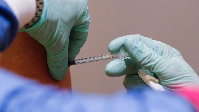 Eine Frau, die in einem Pflegeheim arbeitet, wird in Berlin gegen das Coronavirus geimpft.