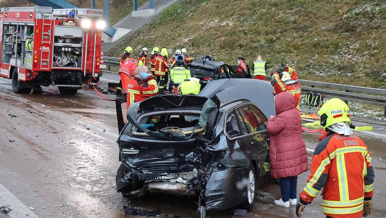 Bayern, Burgau: Feuerwehrleute arbeiten an einer Unfalstelle auf der Autobahn 8.
