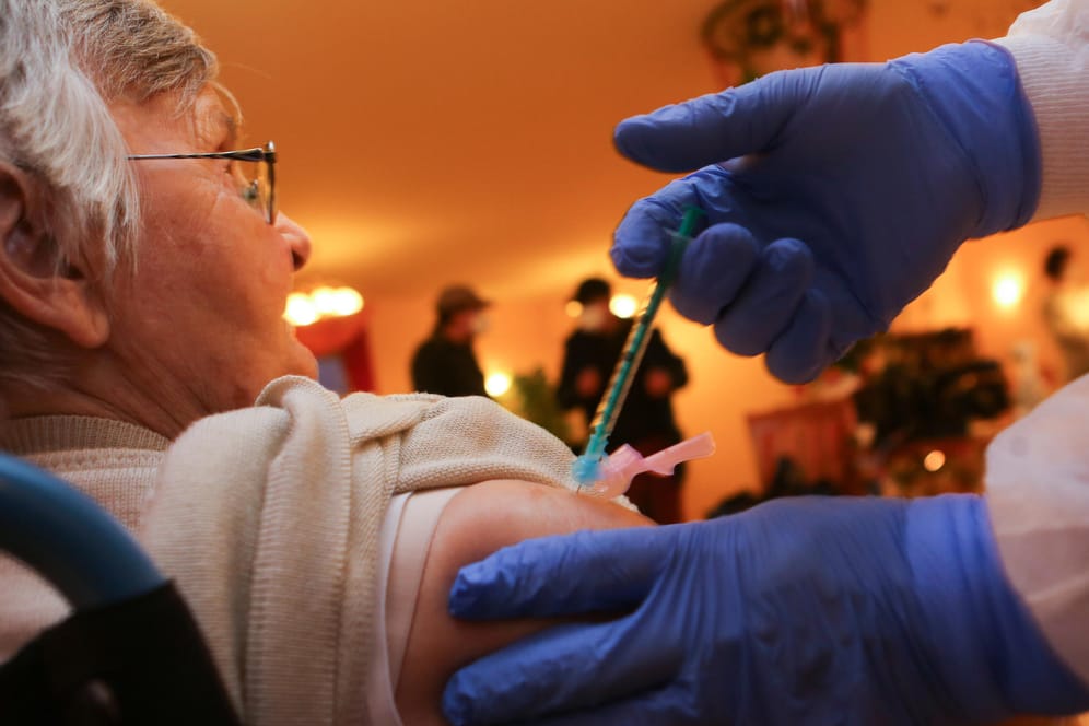 Halberstadt: Krankenpfleger Christopher Bock impft eine Bewohnerin: Markus Söder hat eine schnellere Produktion von Impfstoffdosen gefordert. m