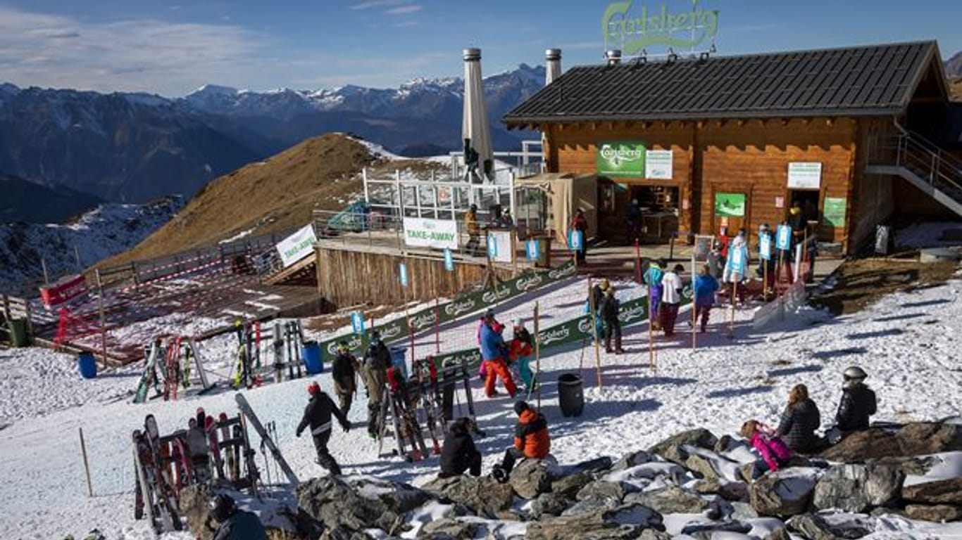 Skifahrer stehen auf einer Piste im Walliser Skigebiet vor einem Restaurant Schlange (Archivbild vom 28.