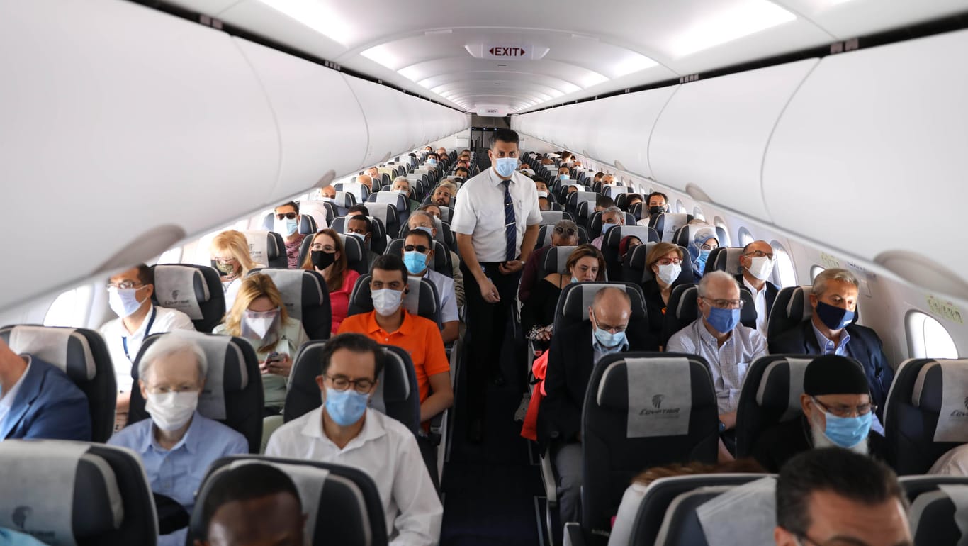 Fluggäste mit Maske: Bald könnten hier nur noch geimpfte Passagiere Platz nehmen – so will es zum Beispiel die australische Airline Quantas (Symbolbild).