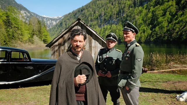 Sepp Rottenbacher (l, Fritz Karl) muss Kaltenbrunner (r, Oliver Masucci) und Schädler (M, George Lenz) auf den See rudern.