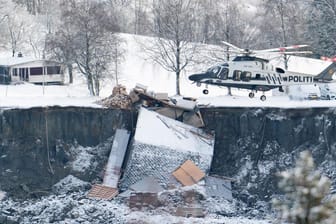 Polizei-Hubschrauber über der Unglücksstelle: Noch immer werden einige Bewohner der Häuser vermisst.