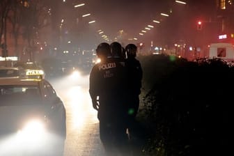 Polizisten gehen in der Silvesternacht über den Kottbusser Damm: Die Einsatzkräfte verzeichnen eine ruhige Silvesternacht.