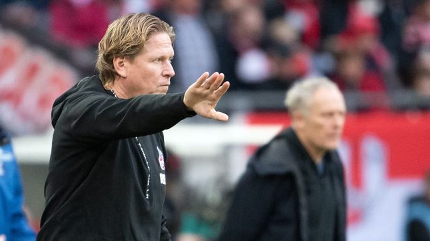 Hat eine hohe Meinung von Freiburg-Trainer Christian Streich (hinten): Kölns Markus Gisdol.