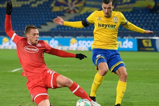 Braunschweigs Dominik Wydra (r) und Rouwen Hennings von Fortuna Düsseldorf kämpfen um den Ball.
