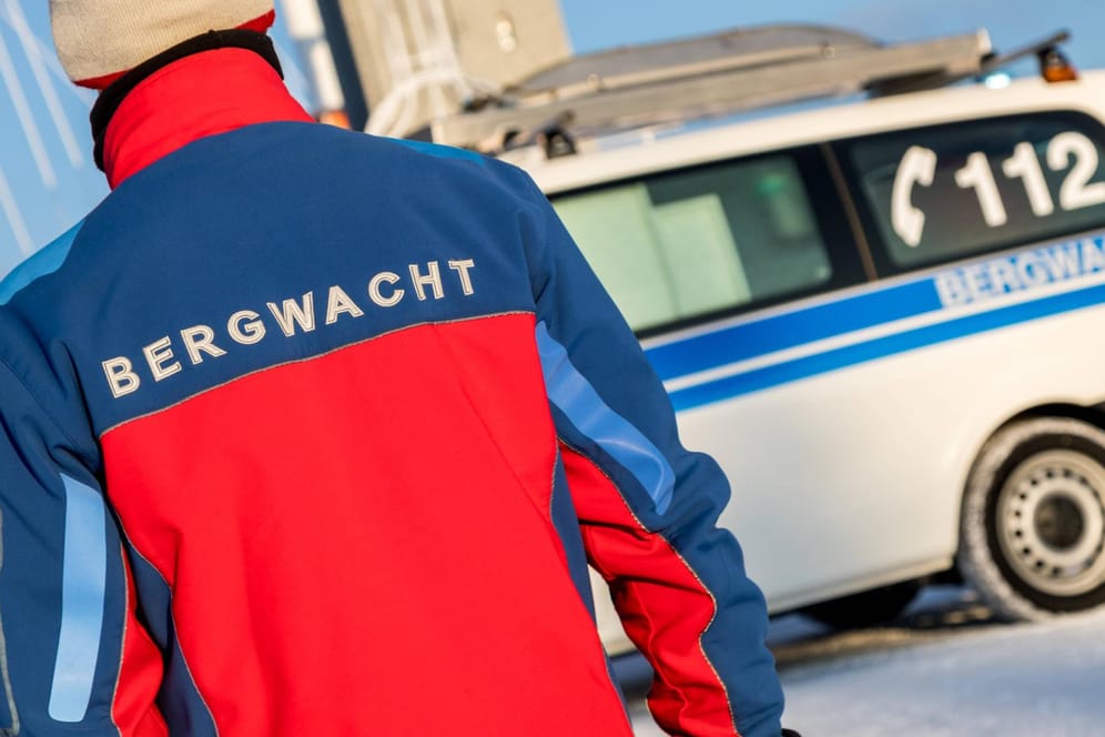 "Bergwacht" steht auf einer Jacke und einem Einsatzfahrzeug: Im Landkreis Garmisch-Partenkirchen haben die Retter einen verirrten Wanderer und seinen Sohn aufgefunden.