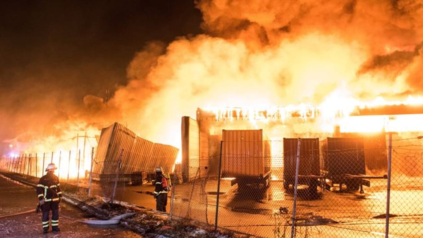 Feuerwehrleute beim Löschen: Im Stadtteil Wilhelmsburg steht eine Lagerhalle in Flammen.