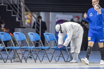 Ein Mitglied des Corona-Desinfektionsteams desinfiziert Stühle vor der WM-Partie Österreich gegen Frankreich.