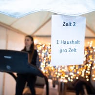 Eine Frau trainiert auf einem Laufband in einem Fitness-Zelt, ein Schild weist auf die Einschränkungen hin. Der Lockdown in Deutschland wird wohl noch verlängert werden. Heute tagen Bund und Länder.