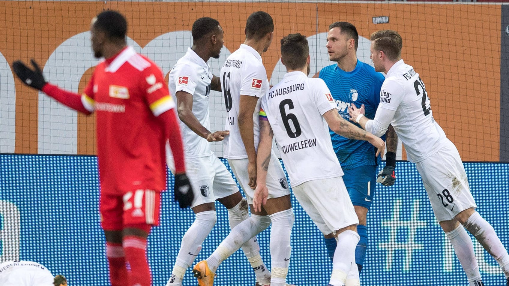 Die Augsburger Spieler feiern Torwart Rafal Gikiewicz (in blau) nach seiner Elfmeter-Parade.