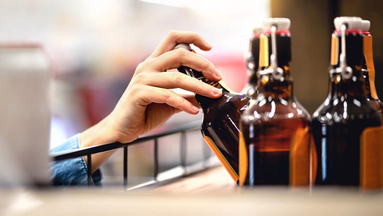 Eine Hand greift eine Flasche Bier (Symbolbild): Die Biersteuer erhöht die Bemessungsgrundlage für die Mehrwertsteuer.