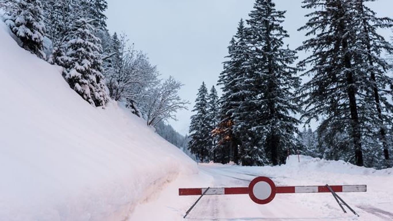Eine Absperrung steht auf dem verschneiten Weg in den Schweizer Bergen nahe Orsieres.