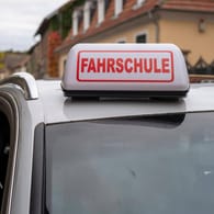 Ein Magnetschild mit dem Wort "Fahrschule" ist auf dem Dach eines Wagens angebracht (Symbolbild): In Hagen wurde eine Fahrschülerin während einer Fahrstunde angefahren.