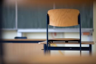 Ein Stuhl in einem Klassenzimmer auf einem Tisch.