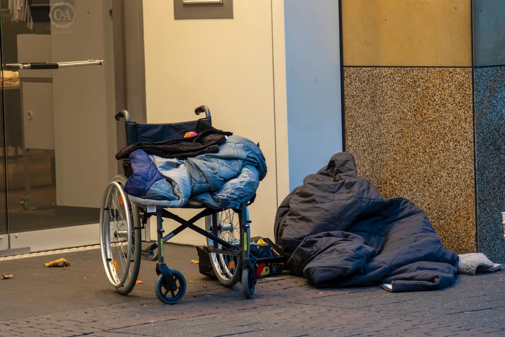 Ein Rollstuhl und ein Schlafsack in der Fußgängerzone: 200 bis 300 obdachlose Menschen sind Schätzungen zufolge bei eisigen Temperaturen in Gefahr.