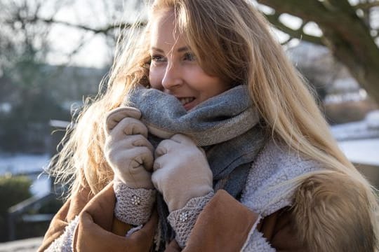 Der Schal schützt die Gesichtshaut vor Kälte - und wo der Stoff nicht hinkommt, sollte man die Haut mit reichhaltiger Pflege eincremen.