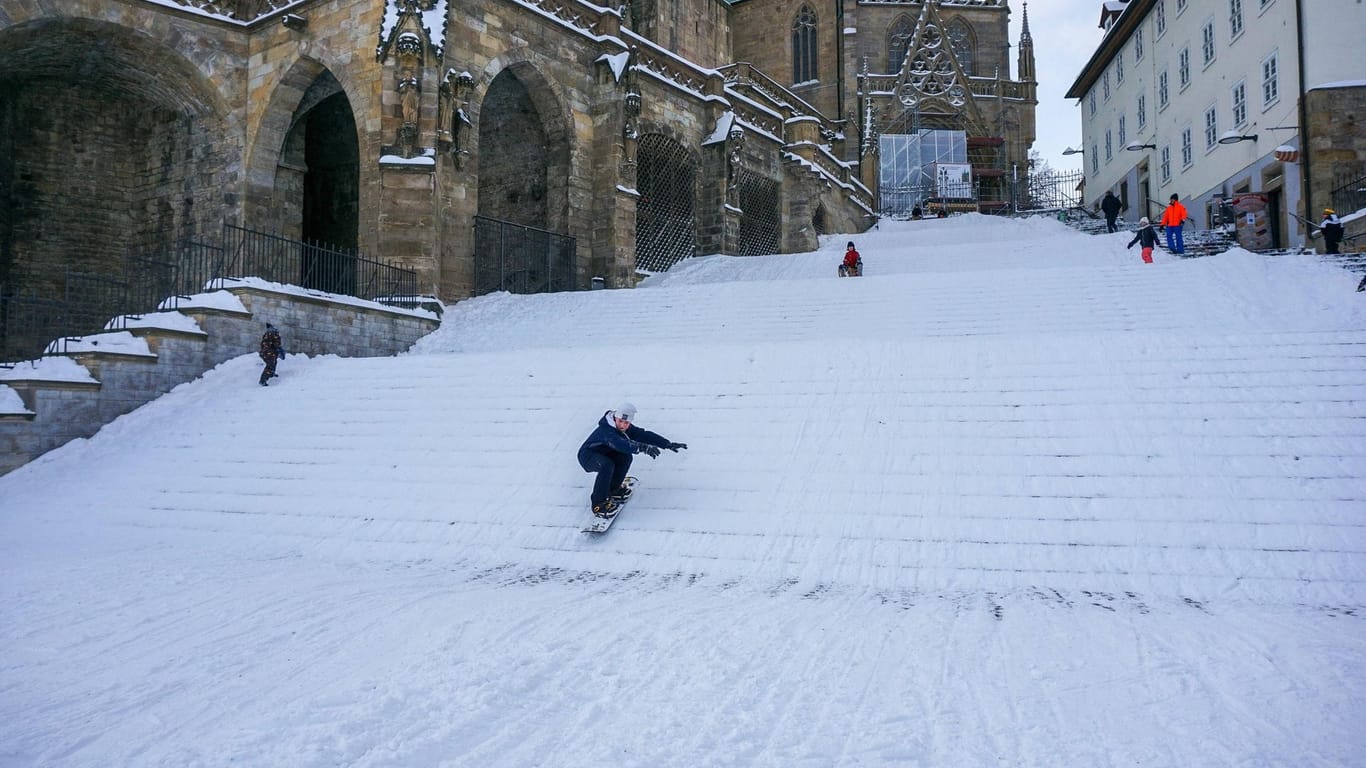 Der Domplatz ist mit einer dicken Schneedecke beleg und wird zum Snowboard fahren genutzt (Archivbild): Die Stadt hat die Treppen nun für Rodelabfahrten gesperrt.