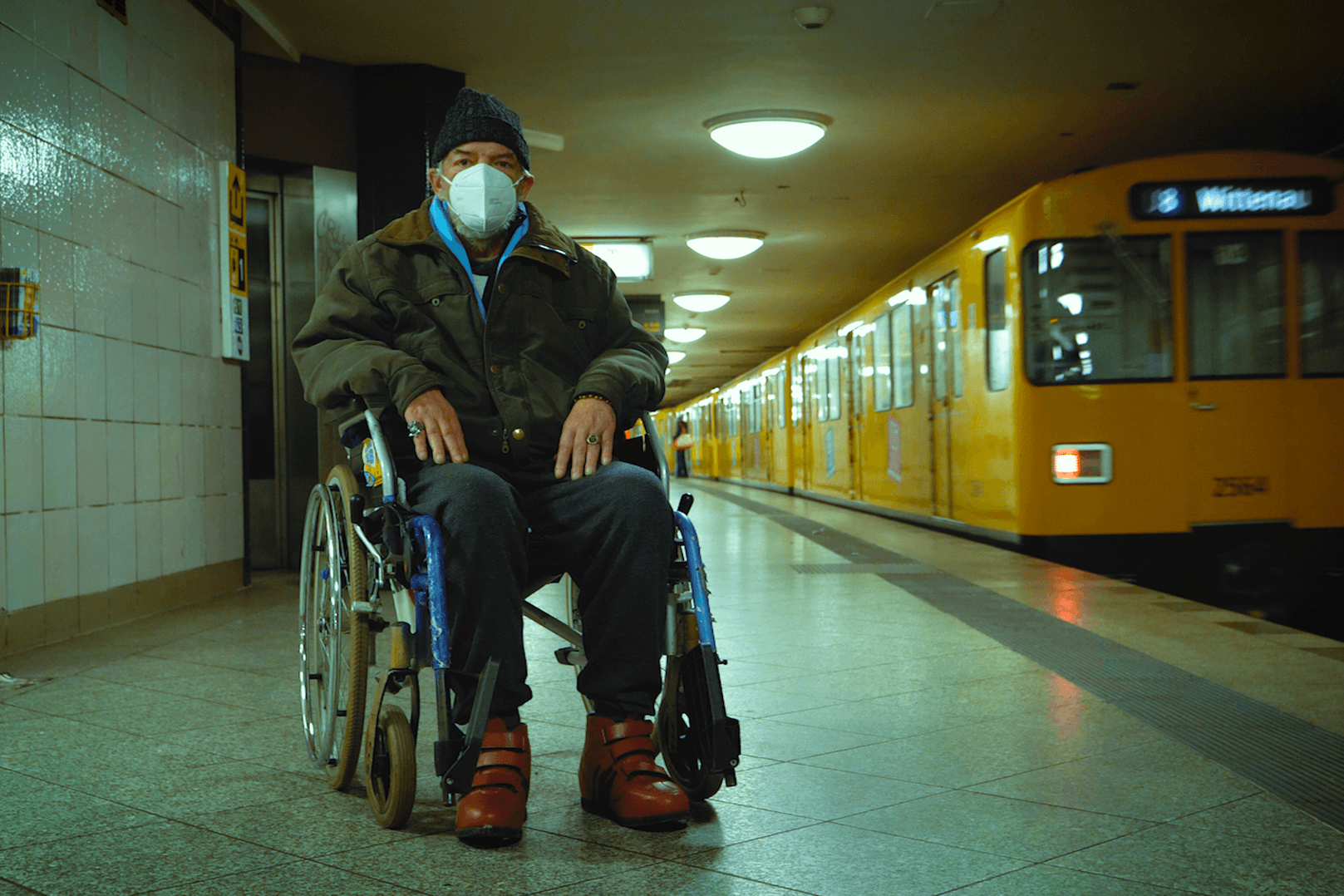 Eine obdachlose Person sitzt in einem Rollstuhl: Menschen von der Straße klären andere obdachlose Personen über Corona auf.