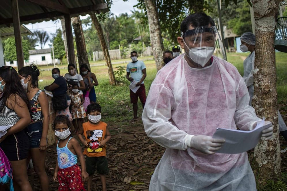 Ein Helfer informiert die Bewohner eines Dorfes im Amazonas über Corona-Tests: Die Virusvariante aus Brasilien soll die Immunabwehr bereits erkrankter Corona-Patienten umgehen können.