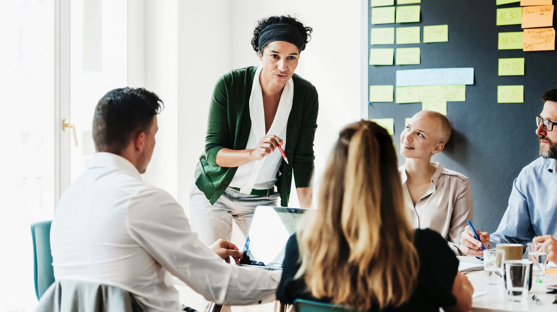 Eine Managerin spricht mit ihrem Team (Symbolbild): Frauen sind in Führungspositionen unterrepräsentiert.