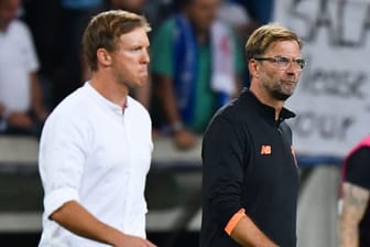 Treffen mit ihren Teams in Budapest aufeinander: Leipzig-Coach Julian Nagelsmann (l) und Liverpools Jürgen Klopp.