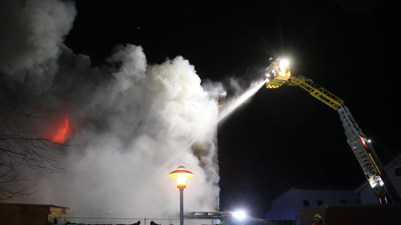 Feuerwehrleute löschen den Brand in dem Reihenhaus: Bei dem Feuer ist ein 54-Jähriger leicht verletzt worden.