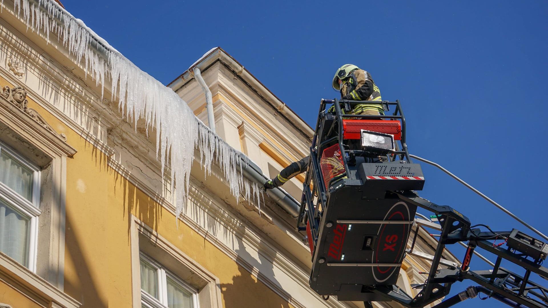 Feuerwehrleute entfernen in Bautzen Eiszapfen von einem Dach (Symbolbild): Auch in Düsseldorf hielten abstürzende Eisgebilde die Feuerwehr auf Trab. Feuerwehrleute entfernen in Bautzen Eiszapfen von einem Dach (Symbolbild): Auch in Düsseldorf hielten abstürzende Eisgebilde die Feuerwehr auf Trab.