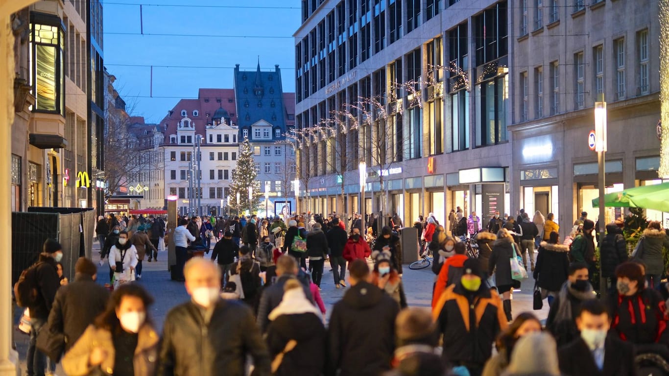 Menschen mit Mund-Nasen-Bedeckungen laufen durch die Innenstadt (Symbolbild): Drei städtische Wissenschaftler wagen einen Blick in die Leipziger Zukunft.