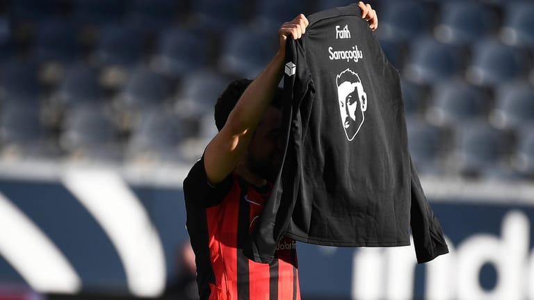 Gedenken an die Opfer des Hanau-Anschlags: Frankfurts Amin Younes hält ein T-Shirt mit dem Konterfei von Fatih Saraçoğlu hoch.