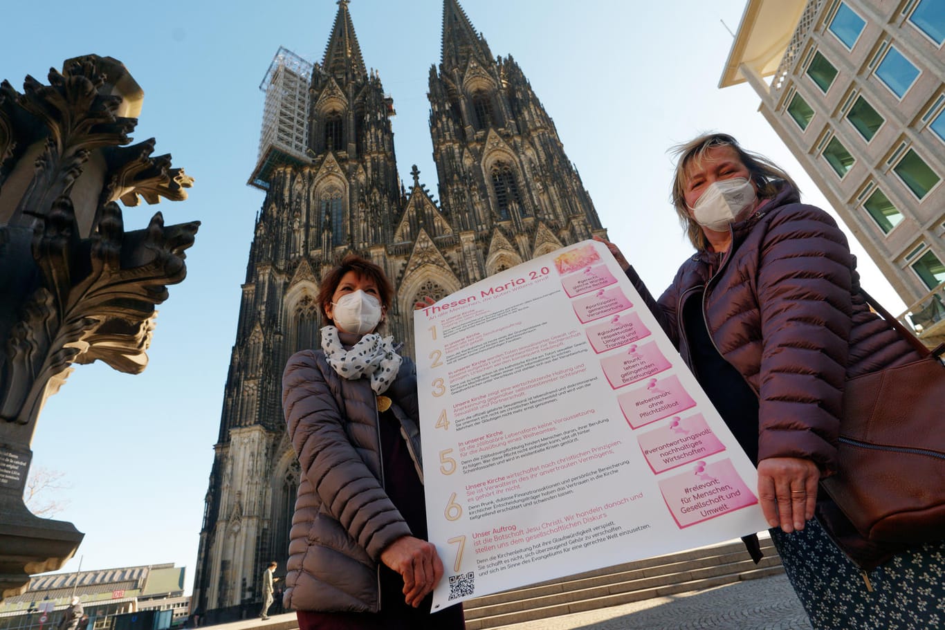 Aktivistinnen der der katholischen Reforminitiative "Maria 2.0" stehen mit einem Thesenpapier vor dem Kölner Dom: Sie fordern unter anderem eine geschlechtergerechte Kirche.